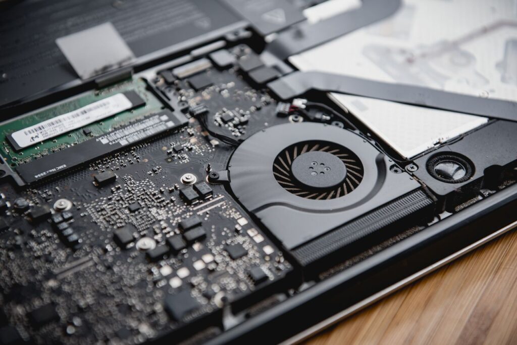 pexels photo 15554492 Detailed view of a laptop's internal circuitry and cooling fan showcasing technology and engineering.
